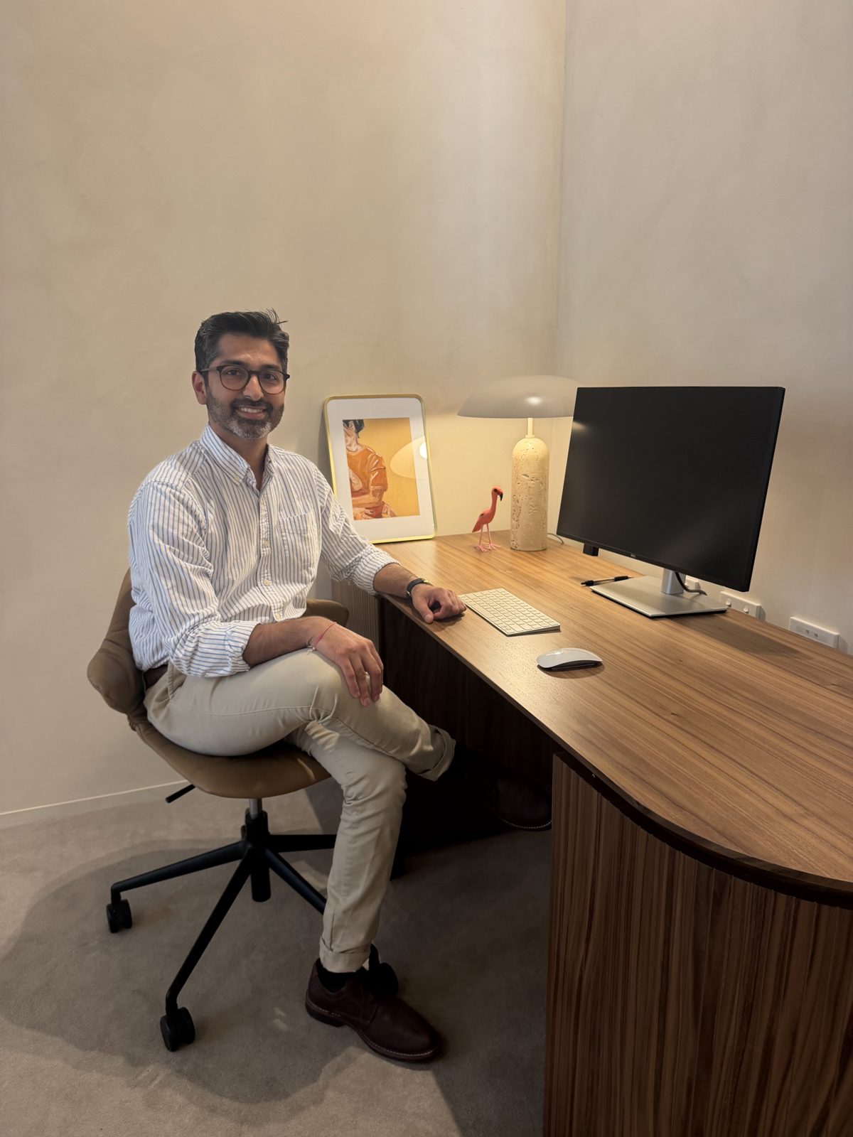 Dr Bharat Visa at his timber desk in the consulting room